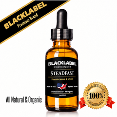 A 1oz amber glass dropper bottle of Blacklabel Steadfast Frankincense & Myrrh essential oil blend