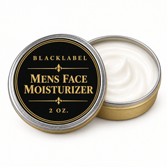 An open round metal tin of Blacklabel Mens Face Moisturizer, showing the white cream inside next to its lid. The lid features a black label with gold lettering and borders, set against a clean white background.