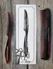 Image of Three combs and a stylized illustration on a wooden surface